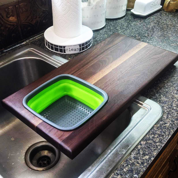 Over The Sink Black Walnut Edge Grain Cutting Board with Colander and Clear Rubber Grip Feet