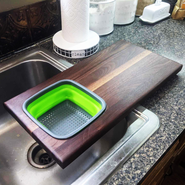 Over The Sink Black Walnut Edge Grain Cutting Board with Colander and Clear Rubber Grip Feet