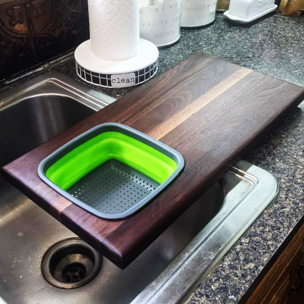 Over The Sink Black Walnut Edge Grain Cutting Board with Colander and Clear Rubber Grip Feet