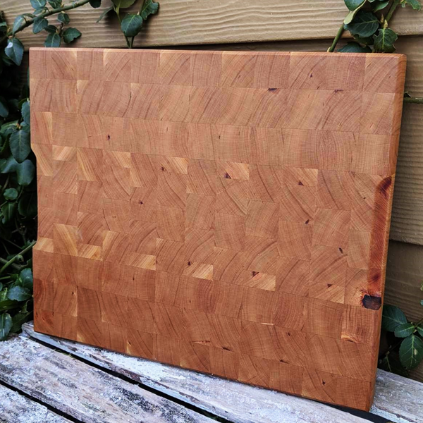 Detail shot of beveled edge craftsmanship on cherry wood cutting board