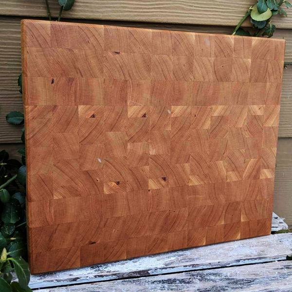 Side-angle view highlighting cherry board's beveled edge and end-grain thickness