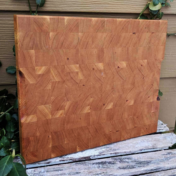 Cherry wood end grain cutting board displayed on kitchen countertop