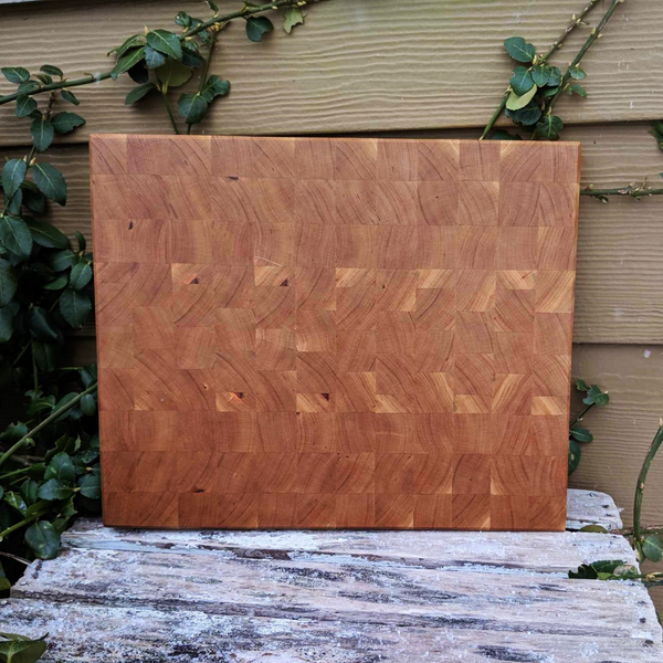 Front view of cherry end grain board with hand grooves and beveled edge