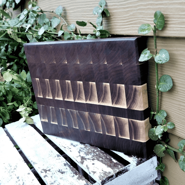 Black Walnut end grain cutting board with hand grooves, finished in a food grade oil and beeswax mixture.