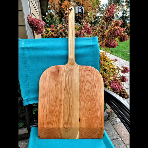 Handcrafted wood pizza peel and pizza cutter.