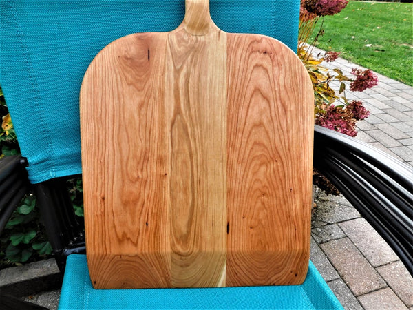 Handcrafted wood pizza peel and pizza cutter.