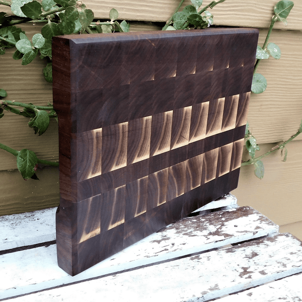Black Walnut end grain cutting board with hand grooves, finished in a food grade oil and beeswax mixture.