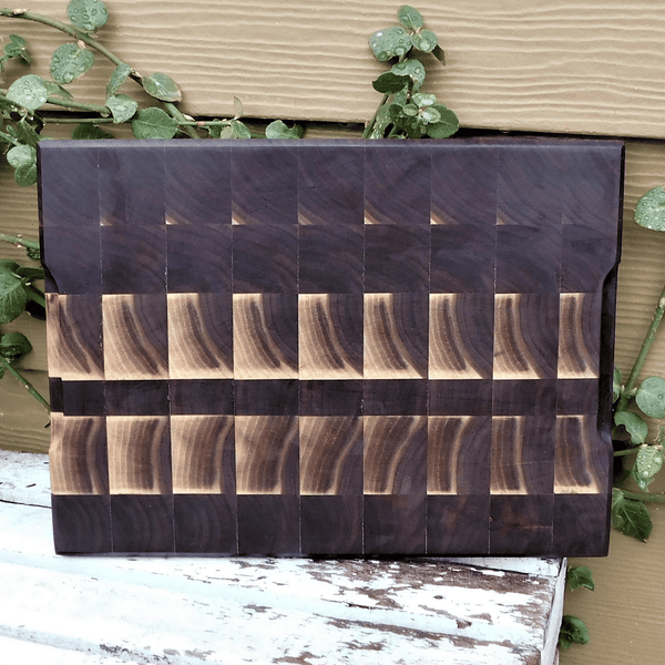 Black Walnut end grain cutting board with hand grooves, finished in a food grade oil and beeswax mixture.