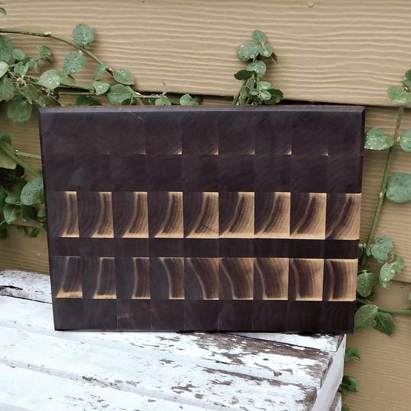 Black Walnut end grain cutting board with hand grooves, finished in a food grade oil and beeswax mixture.