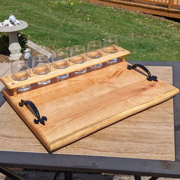 Cherry wood beer flight board with glasses and sauce cups.