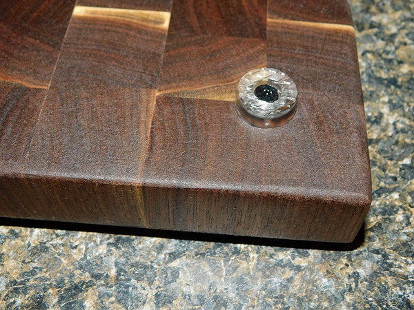 Black Walnut end grain cutting board with clear rubber grip feet and hand grooves. Handmade by Springhill Millworks.