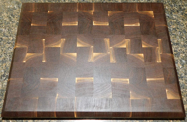 Black Walnut end grain cutting board with clear rubber grip feet and hand grooves. Handmade by Springhill Millworks.