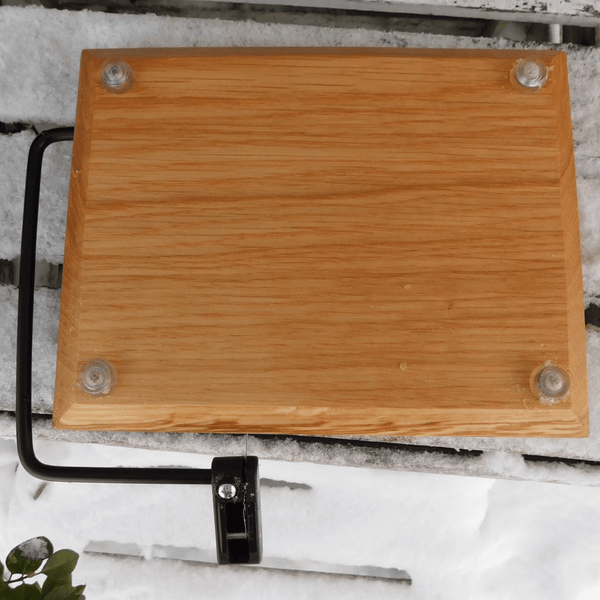 Cherry Wood cheese slicing board with clear rubber grip feet.