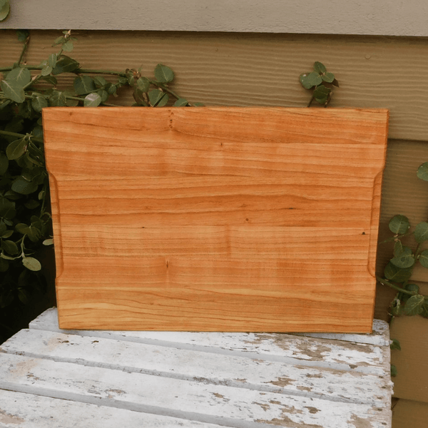 Cherry Wood edge grain cutting board with hand grooves on sides. Handmade in the USA by Springhill Millworks.
