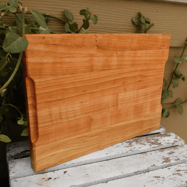 Cherry Wood edge grain cutting board with hand grooves on sides. Handmade in the USA by Springhill Millworks.