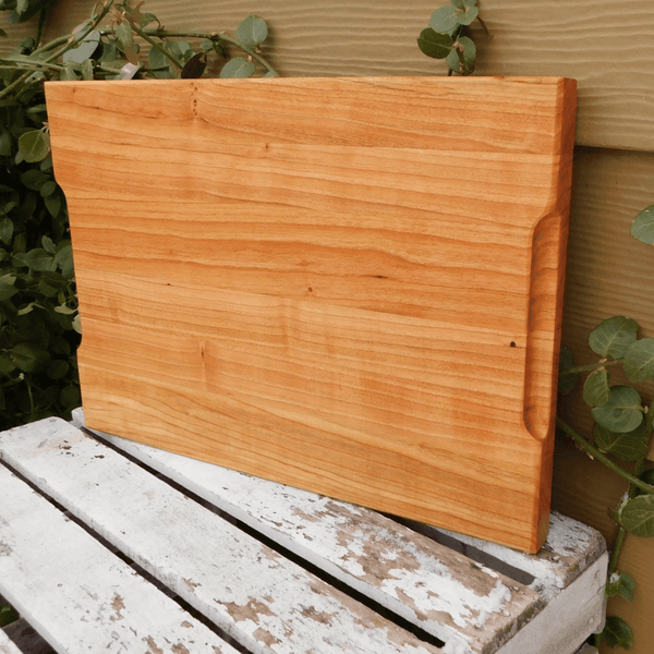 Cherry Wood edge grain cutting board with hand grooves on sides. Handmade in the USA by Springhill Millworks.