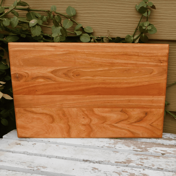 Cherry Wood edge grain cutting board finished in a food grade beeswax and mineral oil mixture to give it a beautiful sheen. Handcrafted in the USA by Springhill Millworks.
