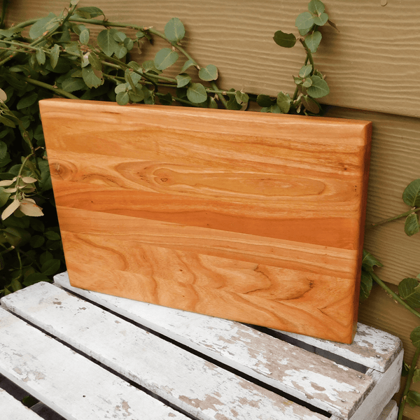 Cherry Wood edge grain cutting board finished in a food grade beeswax and mineral oil mixture to give it a beautiful sheen. Handcrafted in the USA by Springhill Millworks.
