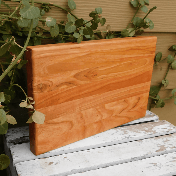 Cherry Wood edge grain cutting board finished in a food grade beeswax and mineral oil mixture to give it a beautiful sheen. Handcrafted in the USA by Springhill Millworks.