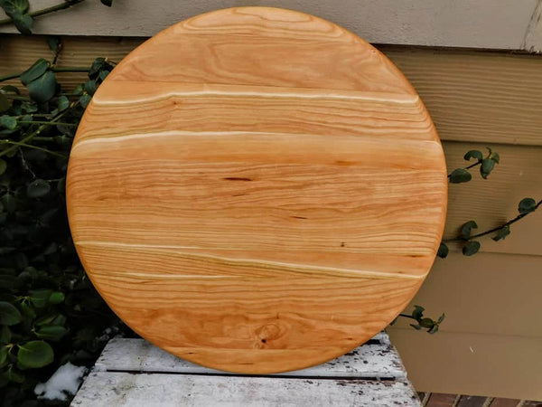 Cherry Wood circular pizza tray, finished in a food grade oil and beeswax mixture. Handmade in the USA by Springhill Millworks.