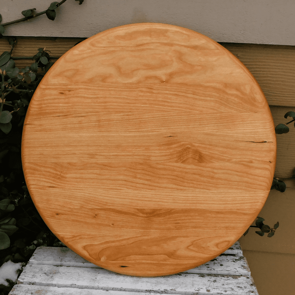 Cherry Wood circular pizza tray, finished in a food grade oil and beeswax mixture. Handmade in the USA by Springhill Millworks.
