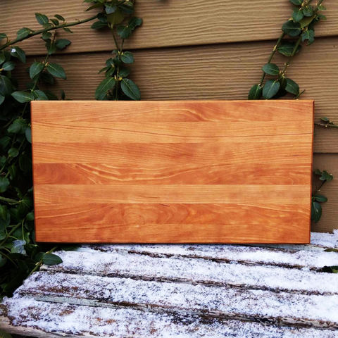 Cherry Wood Edge Grain Cutting Board with Clear Rubber Feet, Hand Grooves on Sides, & a Beveled Edge