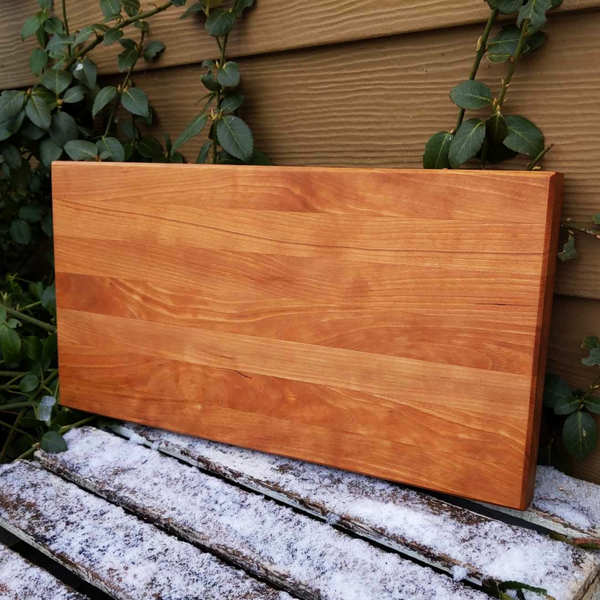 Cherry Wood Edge Grain Cutting Board with Clear Rubber Feet, Hand Grooves on Sides, & a Beveled Edge