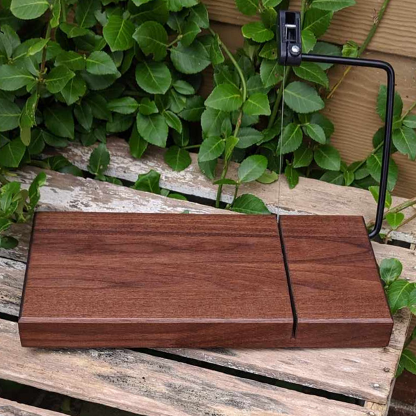 Indulge in the ultimate cheese-slicing experience with our Black Walnut Butcher Block Wood Cheese Slicing Board. Handcrafted and finished with premium food grade oil and beeswax, it boasts a smooth, uniform surface and a luminous sheen. Say goodbye to messy cuts and uneven slices with this high-quality cheese slicer.

Size: 11.25 in. x 5.5&nbsp;in. x 1.25 in. (approximately)