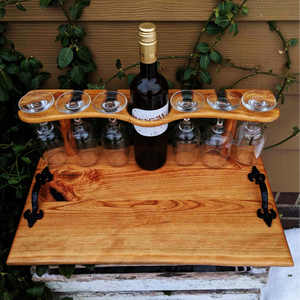 Cherry Wood Wine Charcuterie Board with Six Wine Glasses, Heavy Duty Cast Iron Handles, and Clear Rubber Grip Feet.