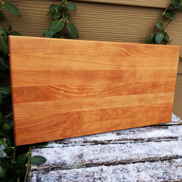 Cherry Wood Edge Grain Cutting Board with Clear Rubber Feet, Hand Grooves on Sides, & a Beveled Edge