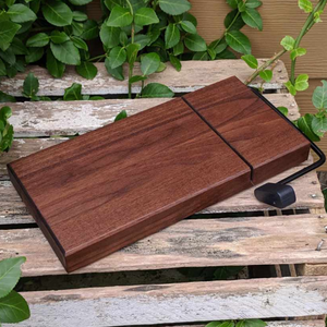 Indulge in the ultimate cheese-slicing experience with our Black Walnut Butcher Block Wood Cheese Slicing Board. Handcrafted and finished with premium food grade oil and beeswax, it boasts a smooth, uniform surface and a luminous sheen. Say goodbye to messy cuts and uneven slices with this high-quality cheese slicer.

Size: 11.25 in. x 5.5&nbsp;in. x 1.25 in. (approximately)