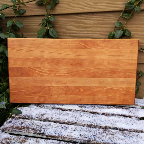 Cherry Wood Edge Grain Cutting Board with Clear Rubber Feet, Hand Grooves on Sides, & a Beveled Edge