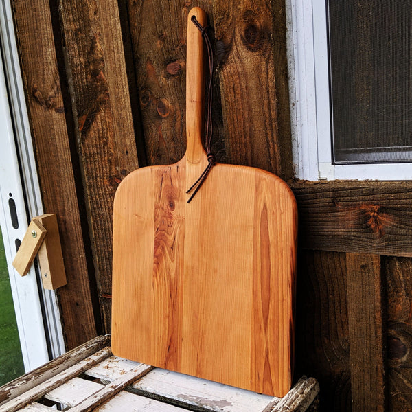 Front view of Cherry Wood Pizza Rocker with ergonomic grip