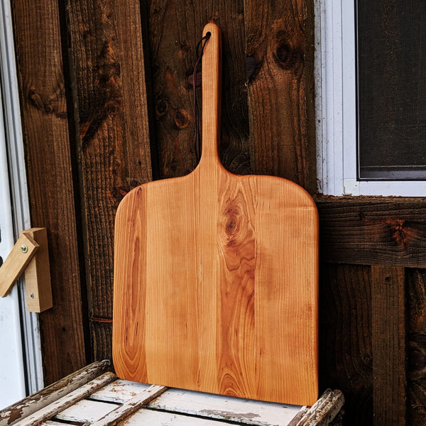 Side view of Cherry Wood Pizza Rocker showing curved edge and smooth bevel