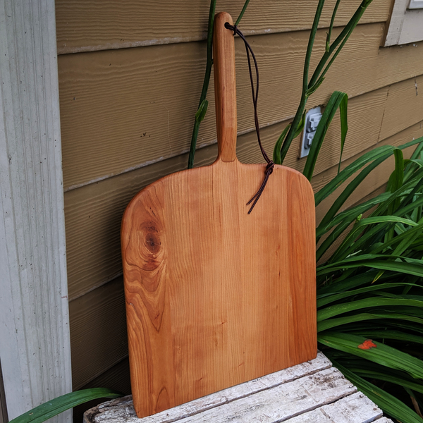 Side view of Cherry Wood Pizza Rocker showing curved edge and smooth bevel
