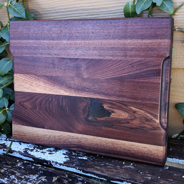 Close-up of carved hand groove on black walnut board