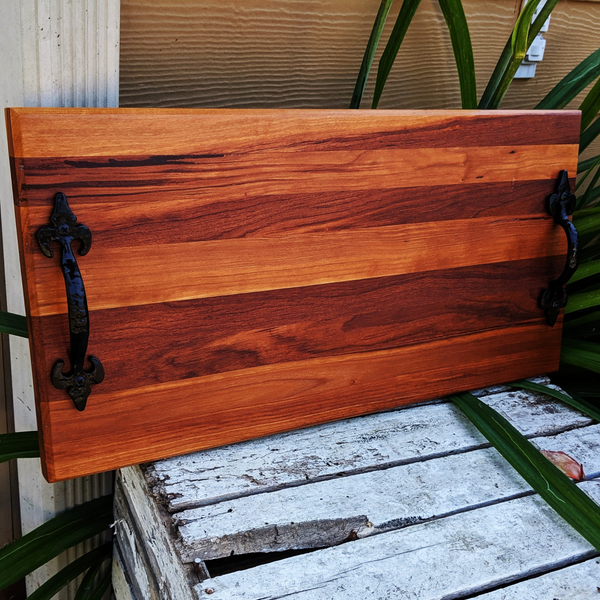 Close-up of spalted cherry wood grain and smooth satin finish on handmade charcuterie board