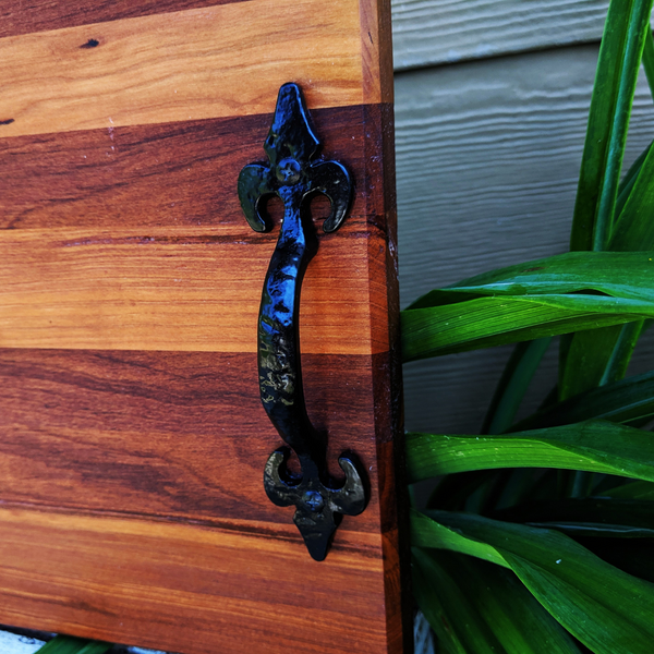 Detail of sturdy cast iron handle on spalted cherry wood charcuterie board