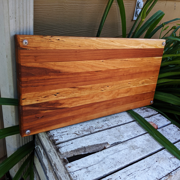 Spalted cherry wood charcuterie board displayed on kitchen counter ready for serving