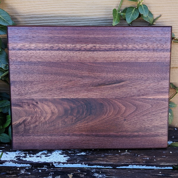 Black walnut cutting board displayed on kitchen countertop