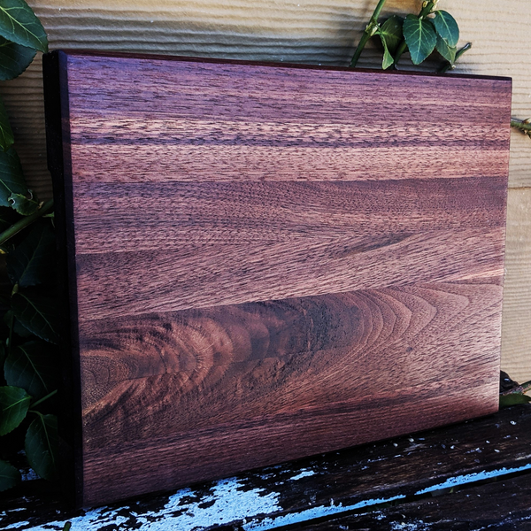 Side angled view of black walnut board showing beveled edge and thickness