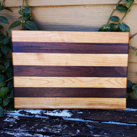 Front view of walnut and cherry edge grain butcher block with hand grooves