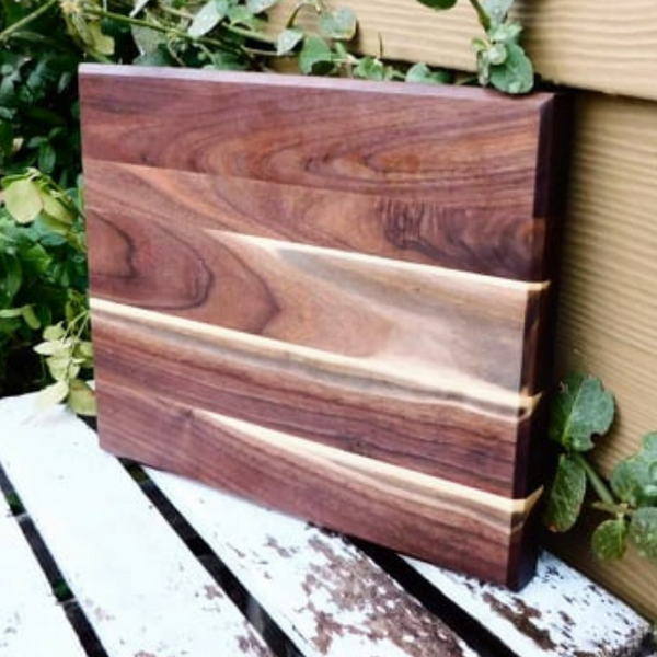 Black Walnut edge grain cutting board with beveled edge.