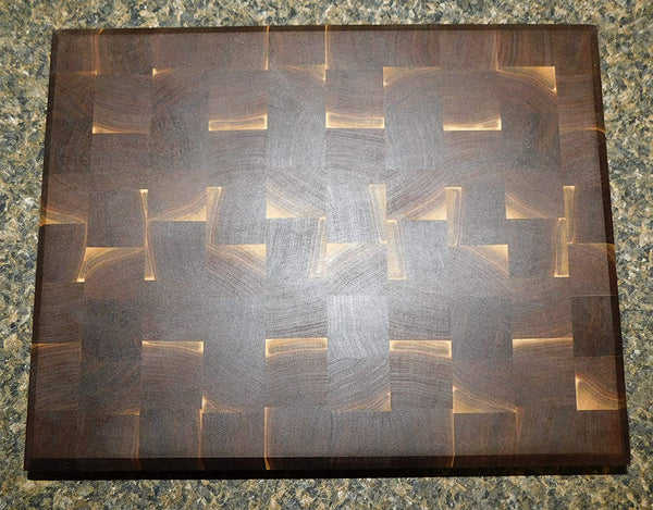 Black Walnut end grain cutting board with clear rubber grip feet and hand grooves. Handmade by Springhill Millworks.