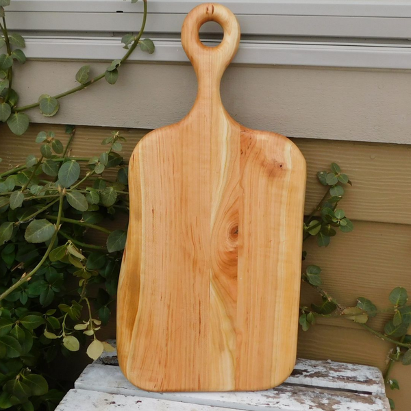 Wooden charcuterie board paddle with handle.