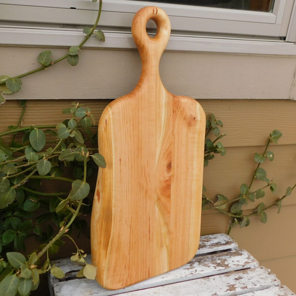 Wooden charcuterie board paddle with handle.