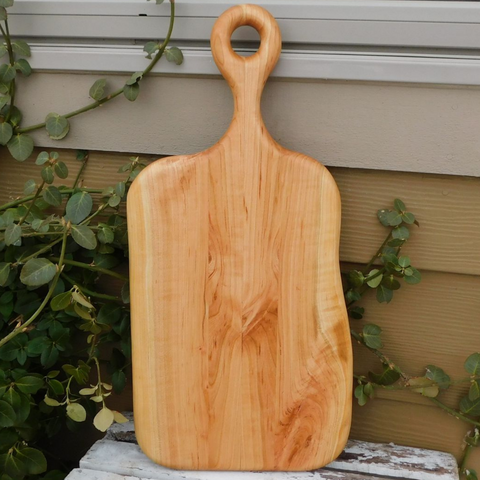 Wooden charcuterie board paddle with handle.