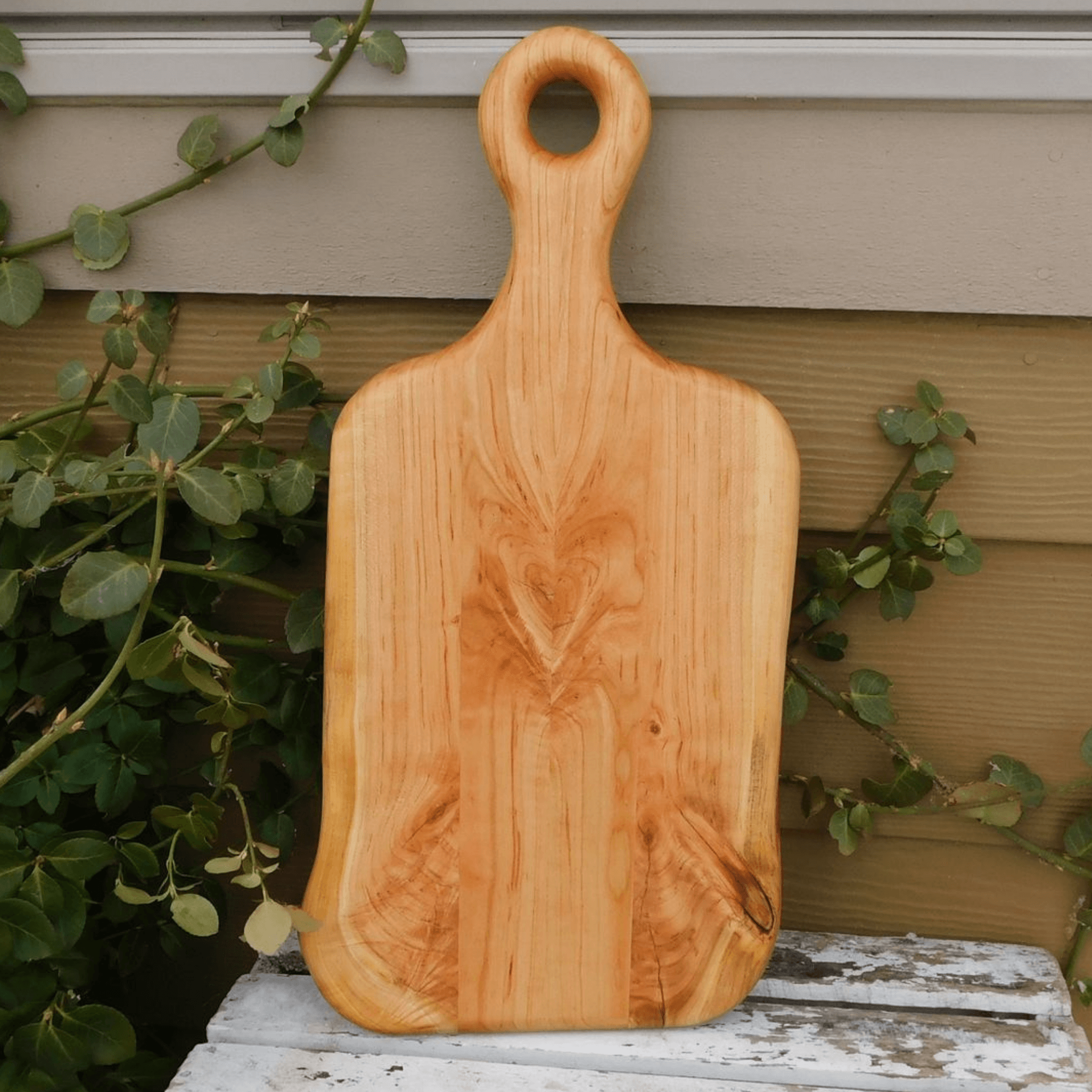 Handcrafted cherry wood charcuterie board paddle with handle. Handmade in the USA.