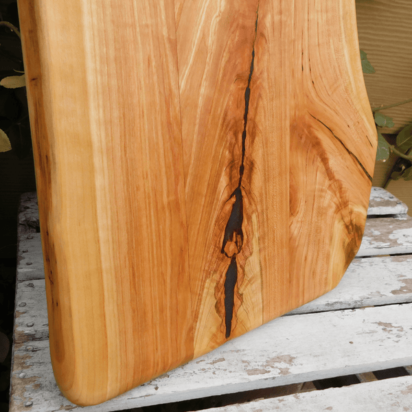 Cherry Wood charcuterie board with handle.