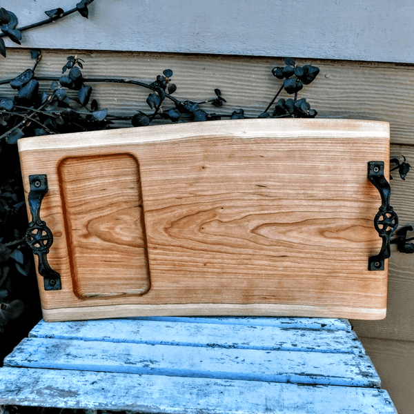 Cherry Wood charcuterie board tray with heavy duty cast iron handles and clear rubber grip feet.